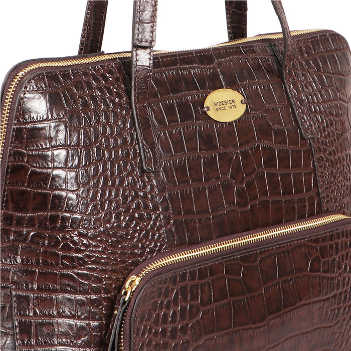 Close-up of a brown croco-embossed Hidesign leather tote bag with dual handles and zipper detailing.