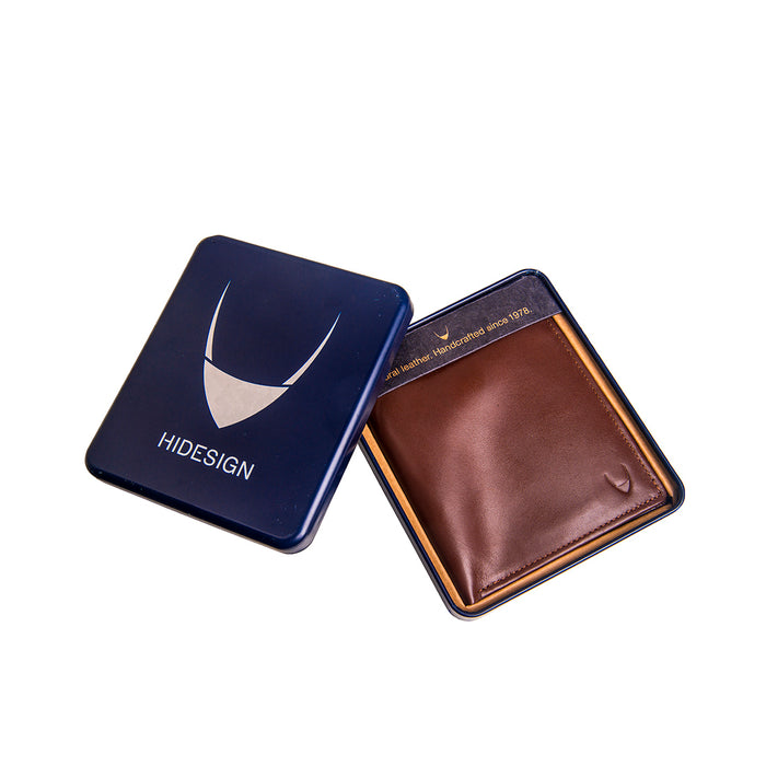 Presented in a blue Hidesign tin, the tan leather bi-fold wallet rests neatly in a fitted tray case.